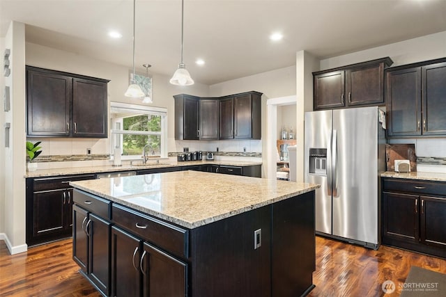 kitchen featuring dark wood-style floors, a center island, stainless steel fridge, and backsplash