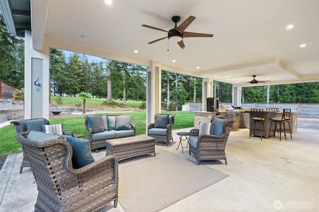 view of patio / terrace with an outdoor kitchen, ceiling fan, and an outdoor hangout area