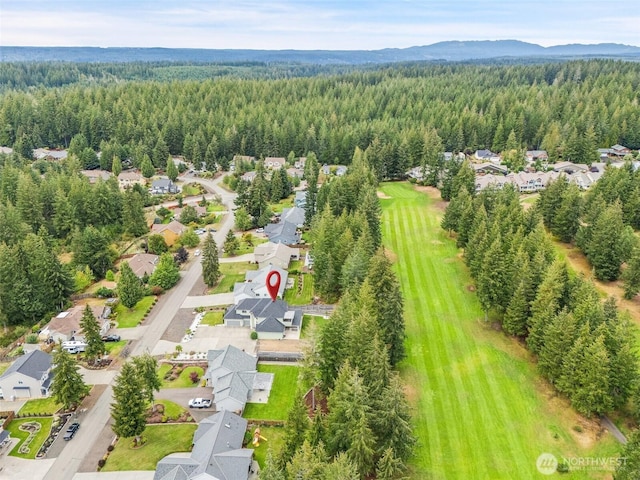 birds eye view of property featuring a forest view, a residential view, and a mountain view