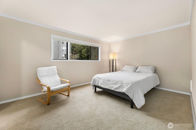 carpeted bedroom featuring baseboards and crown molding