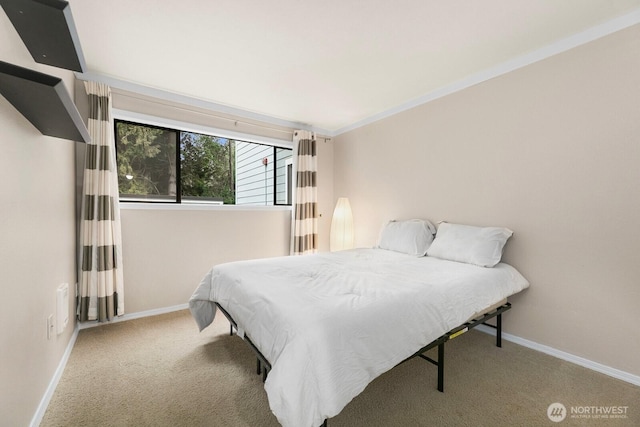 bedroom featuring carpet floors, baseboards, and ornamental molding