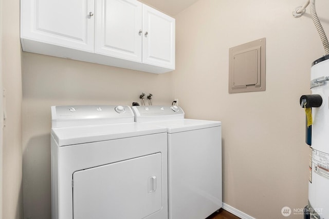 laundry area featuring electric panel, cabinet space, and washer and clothes dryer