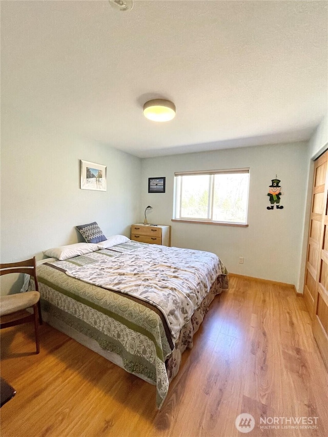 bedroom featuring light wood-type flooring and baseboards