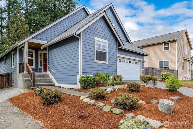 view of front of house with a garage and fence