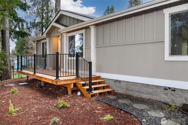 entrance to property featuring crawl space and a deck