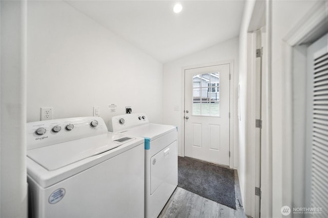 laundry room featuring laundry area, light wood-type flooring, and washer and dryer