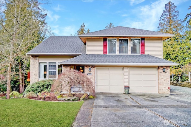 tri-level home featuring a garage, brick siding, a shingled roof, driveway, and a front yard