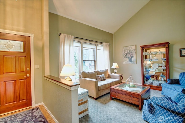 living room featuring high vaulted ceiling and baseboards