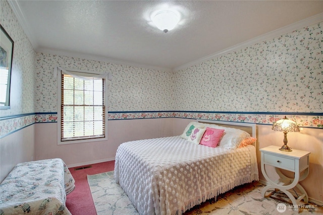 bedroom with visible vents, crown molding, and wallpapered walls