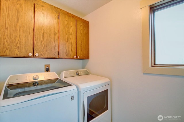 laundry area with cabinet space and washing machine and clothes dryer