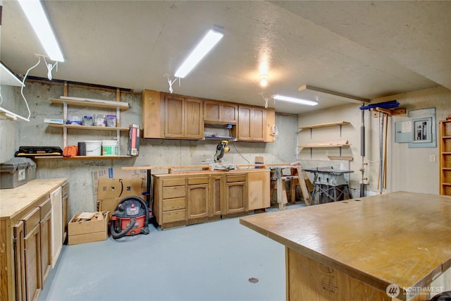 kitchen with wooden counters, finished concrete flooring, and open shelves