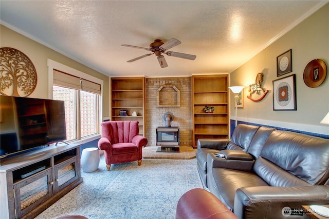 living room with a wood stove, crown molding, a ceiling fan, and a textured ceiling