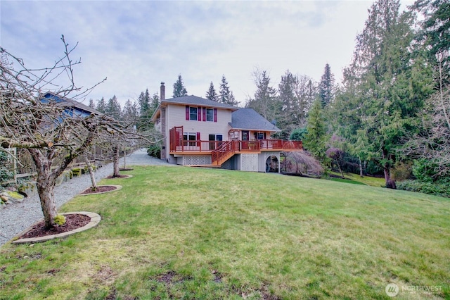 rear view of house with a wooden deck, a chimney, stairway, and a yard