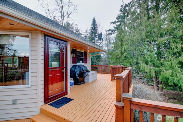 wooden terrace featuring a grill