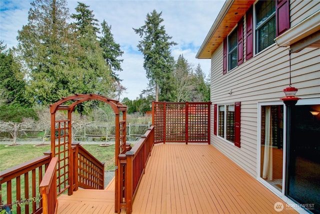 wooden deck with a yard and fence