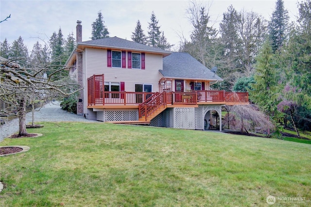 back of property with a deck, a lawn, a chimney, and stairs