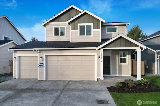 view of front of property with board and batten siding, concrete driveway, roof with shingles, and a garage