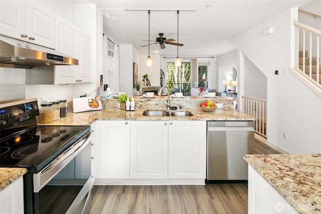 kitchen featuring white cabinets, under cabinet range hood, stainless steel appliances, and a sink