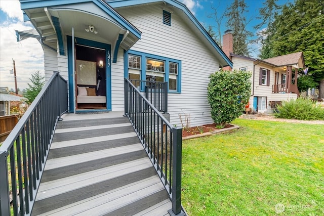 view of exterior entry featuring a yard