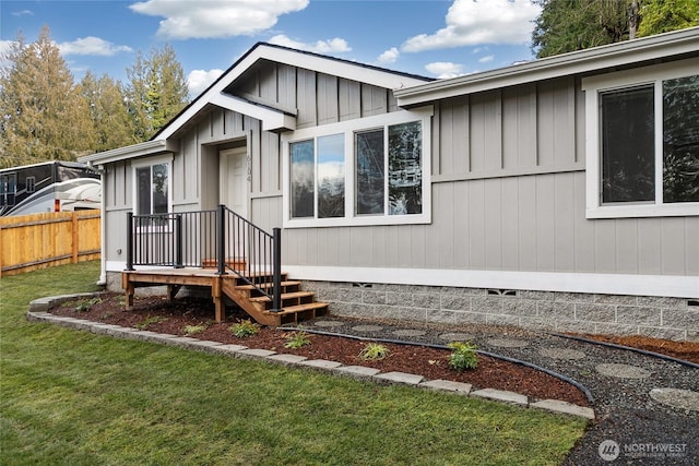 exterior space with crawl space, fence, and a front lawn