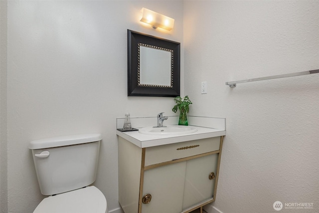 bathroom featuring toilet and vanity