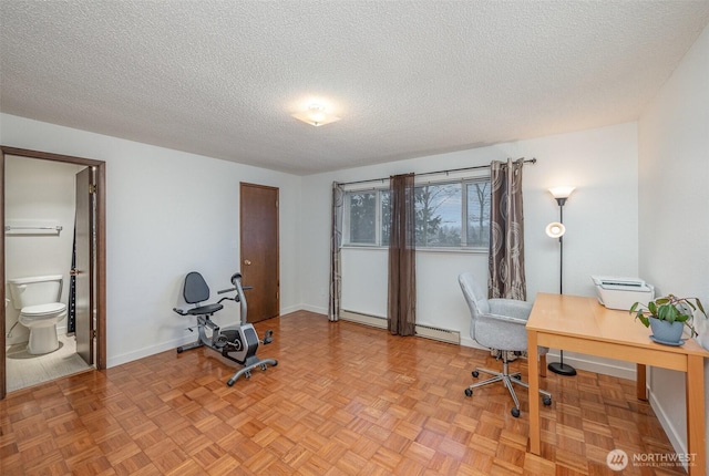 office space with baseboards, a textured ceiling, and baseboard heating