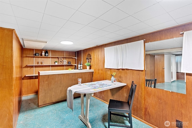 dining room featuring wood walls