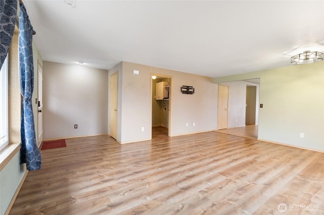 unfurnished room with light wood-style flooring