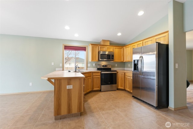 kitchen featuring lofted ceiling, recessed lighting, a sink, light countertops, and appliances with stainless steel finishes