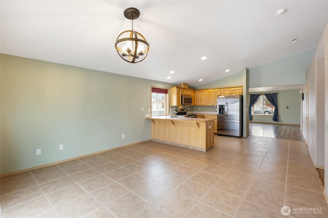 kitchen with a peninsula, vaulted ceiling, stainless steel appliances, light countertops, and pendant lighting