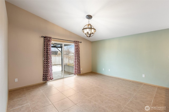 unfurnished room featuring vaulted ceiling, light tile patterned floors, a chandelier, and baseboards