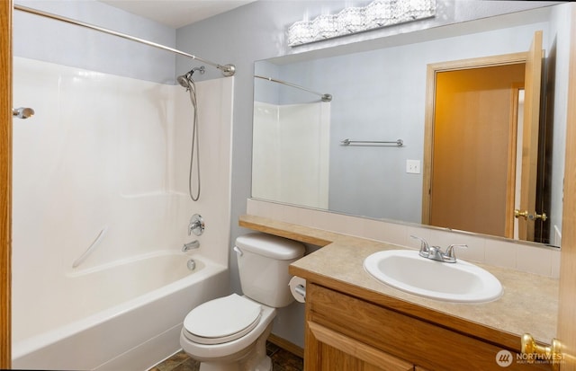 bathroom with tub / shower combination, vanity, and toilet