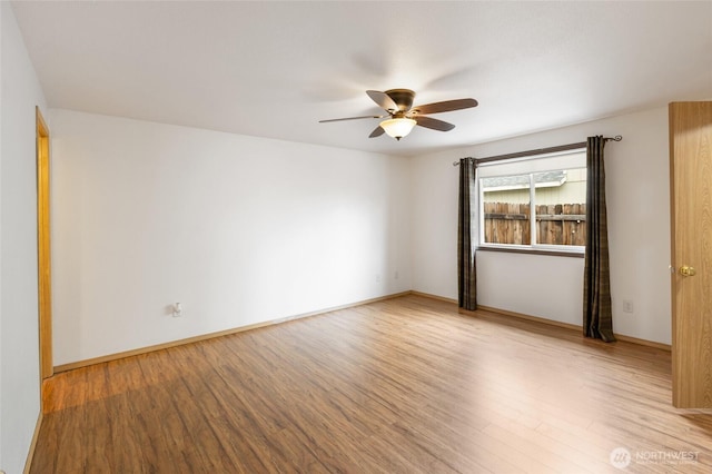 unfurnished room with baseboards, ceiling fan, and light wood finished floors