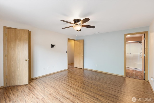 unfurnished bedroom with light wood finished floors, visible vents, baseboards, connected bathroom, and a ceiling fan