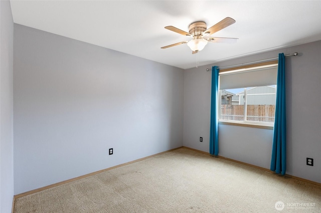 empty room with carpet floors, ceiling fan, and baseboards