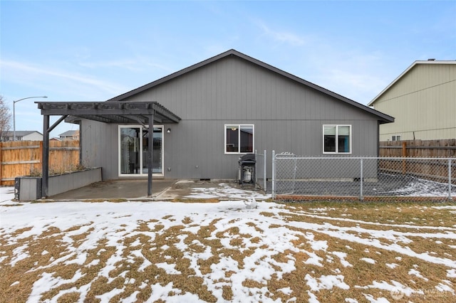 snow covered property featuring fence and a pergola