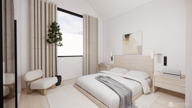 bedroom with lofted ceiling and light wood-style floors