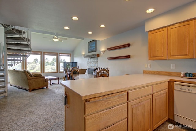 kitchen with a peninsula, carpet, white dishwasher, and light countertops