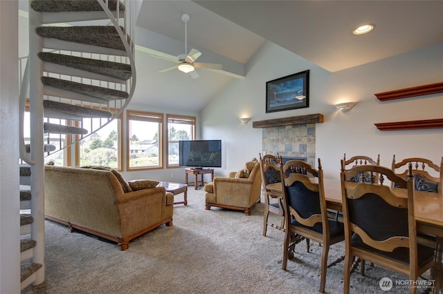 carpeted living room with a fireplace, recessed lighting, lofted ceiling with beams, ceiling fan, and stairs