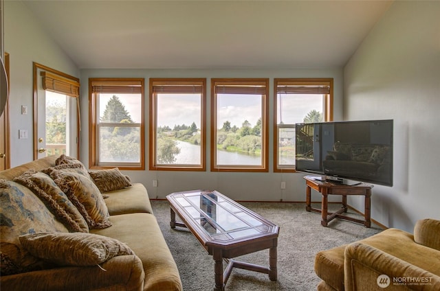 carpeted living area with vaulted ceiling