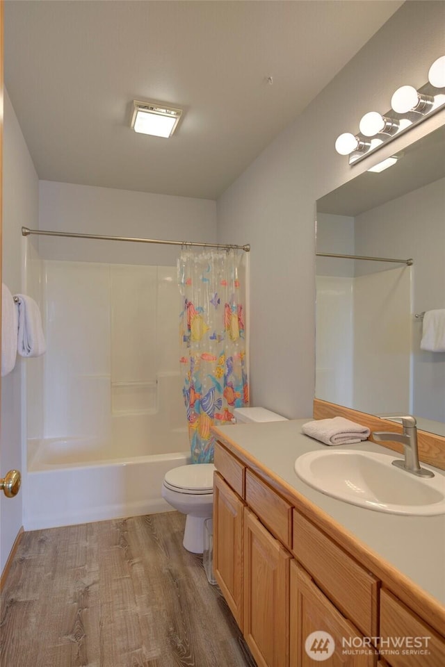 full bathroom featuring vanity, shower / bathtub combination with curtain, toilet, and wood finished floors