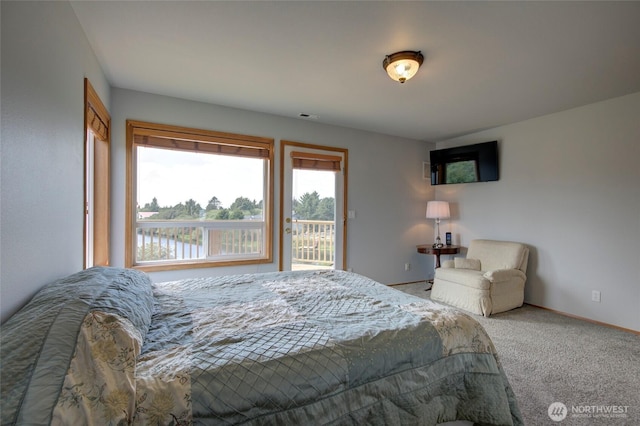 bedroom featuring access to outside, carpet flooring, visible vents, and baseboards