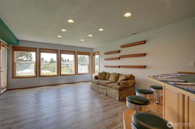 living area featuring recessed lighting, baseboards, and wood finished floors