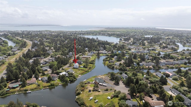 birds eye view of property with a water view and a residential view