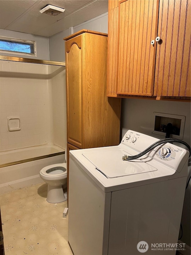 clothes washing area featuring washer / clothes dryer, visible vents, and laundry area