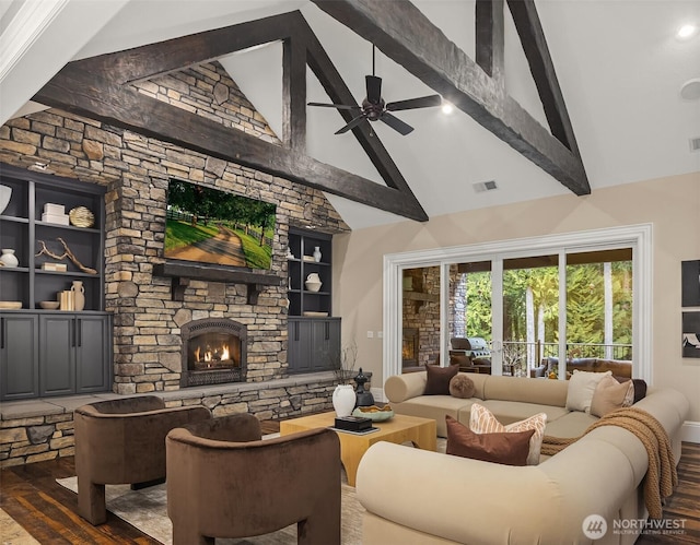 living area with beam ceiling, dark wood finished floors, a fireplace, visible vents, and a ceiling fan