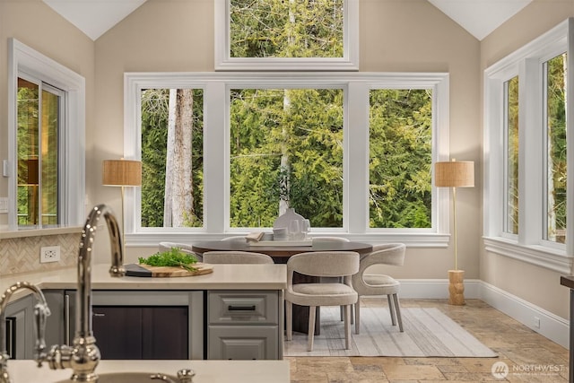 sunroom / solarium with lofted ceiling and a wealth of natural light