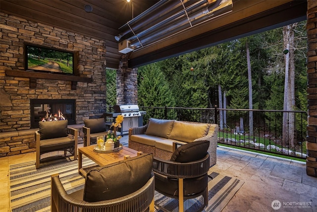 view of patio / terrace featuring an outdoor living space with a fireplace and a grill