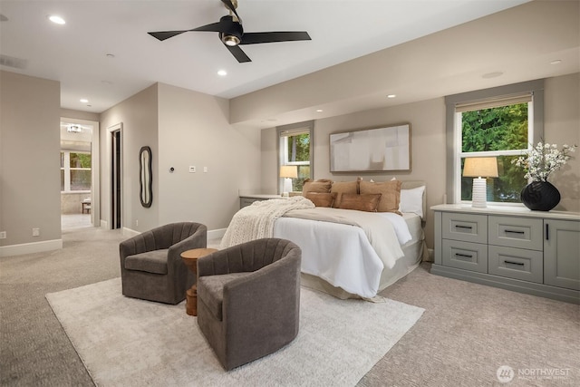 bedroom featuring recessed lighting, light carpet, connected bathroom, ceiling fan, and baseboards