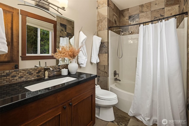 bathroom featuring vanity, shower / tub combo, backsplash, and toilet